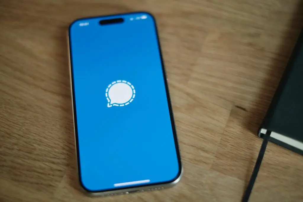 A cell phone sitting on top of a wooden table