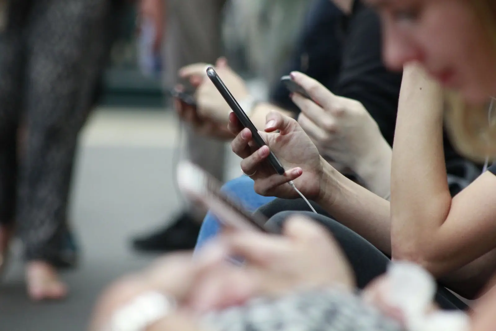 Woman checking phone (Image credit: Unsplash | ROBIN WORRALL)