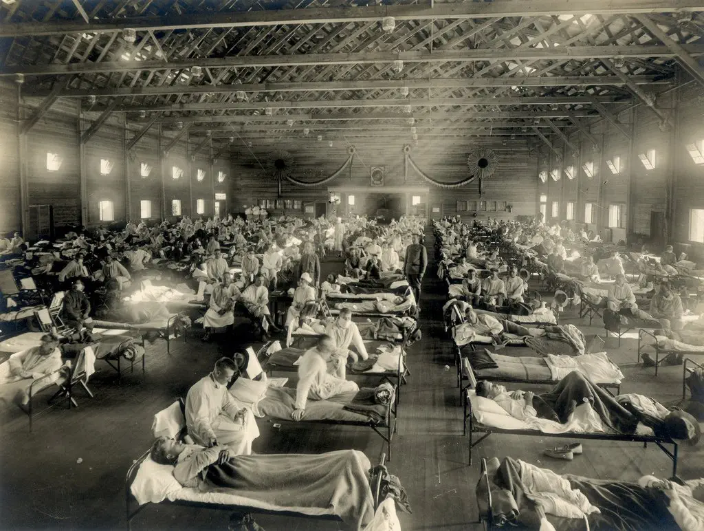 Image credit: https://diplycom5cc47.zapwp.com/q:i/r:0/wp:1/w:1/u:https://commons.wikimedia.org/wiki/File:Emergency_hospital_during_Influenza_epidemic,_Camp_Funston,_Kansas_-_NCP_1603.jpg